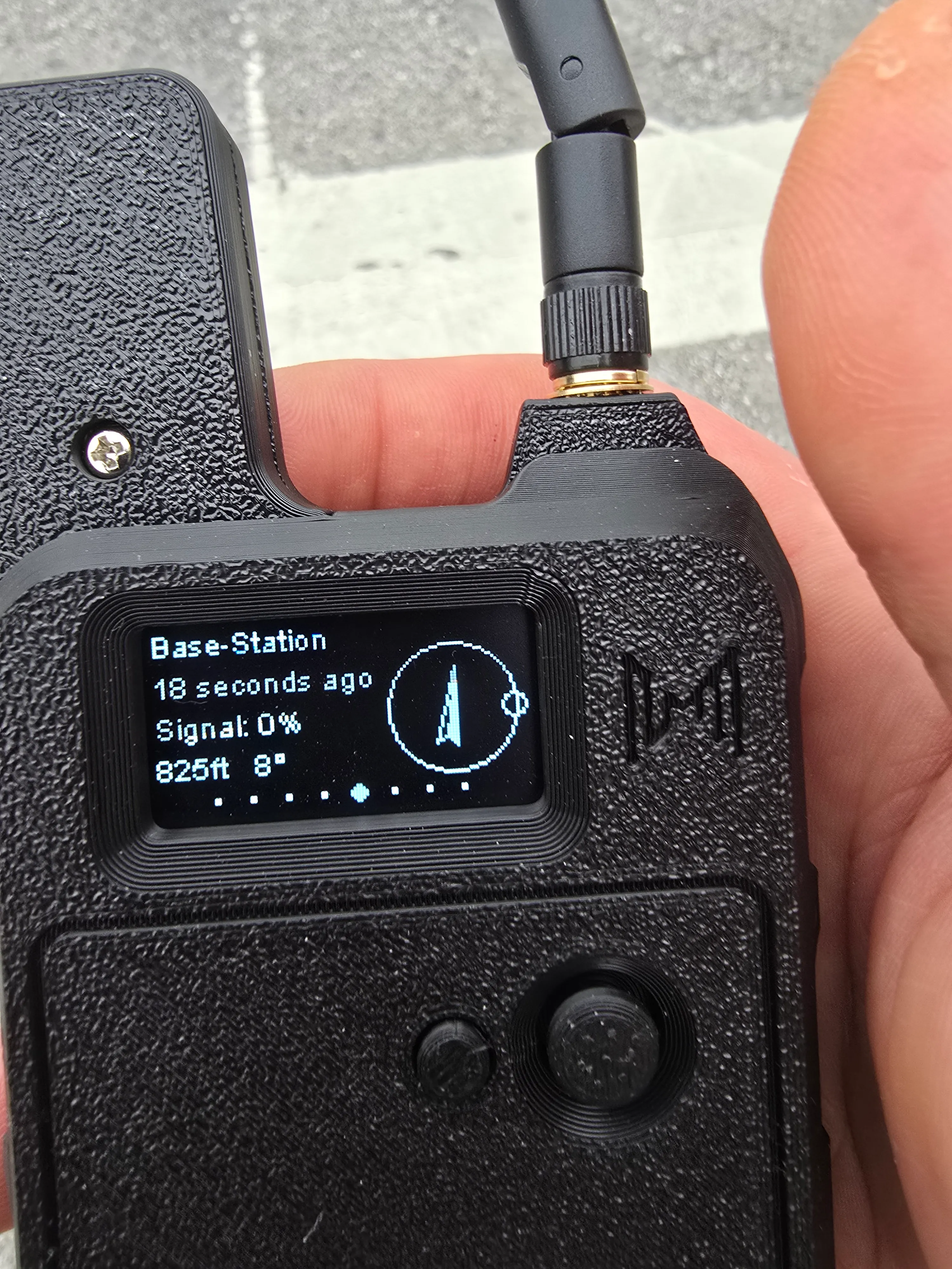 The collar controller's OLED at the start of the walk, link alive: it shows the Base-Station node heard seconds ago, with a compass arrow and distance — a healthy, fresh heartbeat.