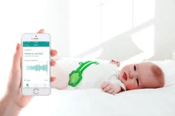 Mimo Smart Baby onesie with the turtle-shaped sensor monitor — tracks sleep status, breathing, and body position via iPhone or Android