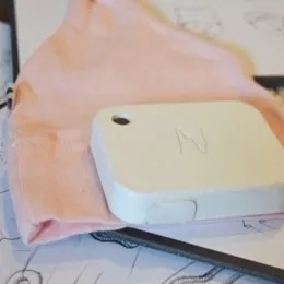 Neopenda newborn vital-signs monitor built into a baby hat — measures temperature, heart rate, respiratory rate, and blood oxygen for up to 24 babies on one tablet