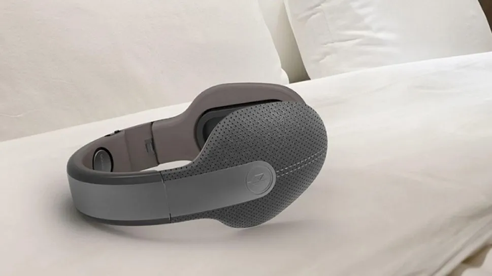 Kokoon in-ear sleep headphones resting on a pillow — wearable designed to improve sleep quality